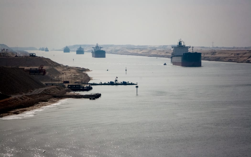 Loaded containers stacked on top of a cargo ship in sigle fine sailing in a canal on Janvier 20, 2017 in Suez Canal, Red sea, Egypt.