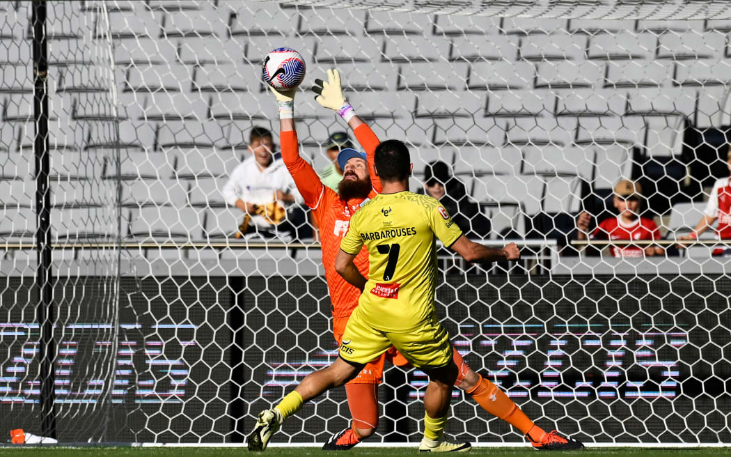 Sydney FC goal keeper Andrew Redmayne makes a save from Wellington striker Kosta Barbarouses.