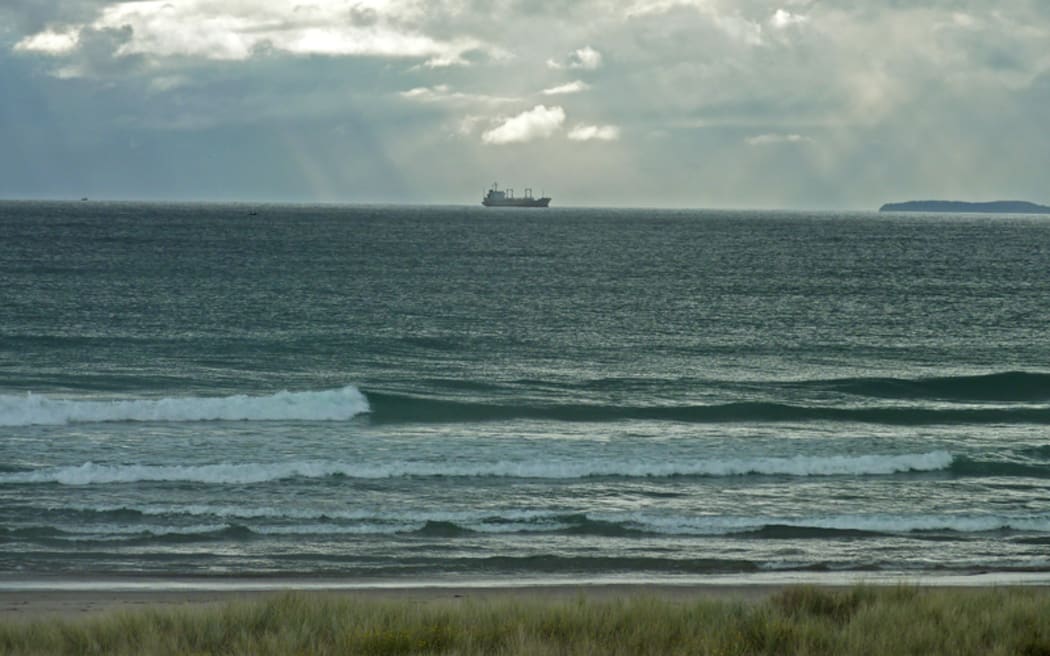 Ship cruising south past Mount Maunganui.