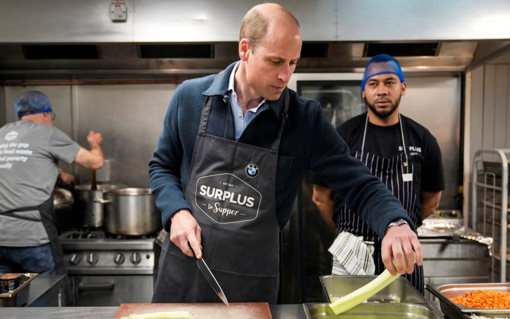 Britain's Prince William, Prince of Wales cuts celery as he helps to make a bolognese sauce during a visit to Surplus to Supper, a surplus food redistribution charity, in Sunbury-on-Thames, Surrey, England, on April 18, 2024. (Photo by Alastair Grant / POOL / AFP)