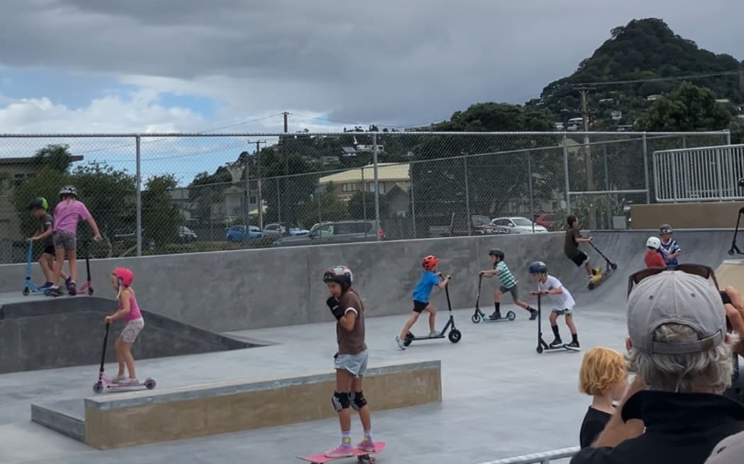 Kids test out their scootering and skateboarding skills at the new Tairua Skate Park, moments after it opened.