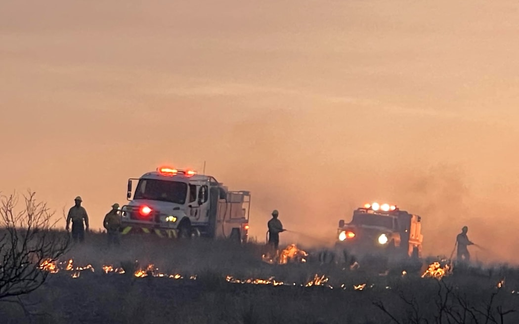 This handout picture courtesy of the Amarillo Fire Department taken on 28 February, 2024, shows Amarillo firefighters during mop up operations at the Windy Deuce fire north of Amarillo, Texas.