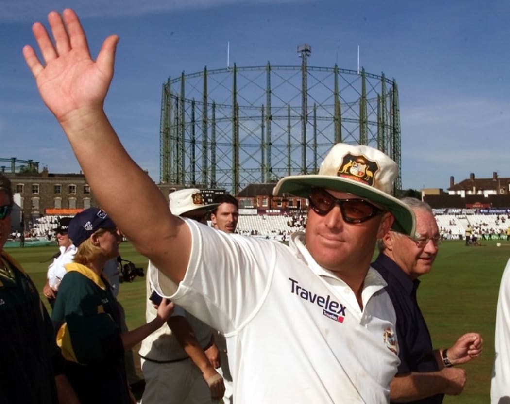 Shane Warne waves to the crowds after Australia defeated England on the final day of the fifth Test Match at the Oval August 2001.
