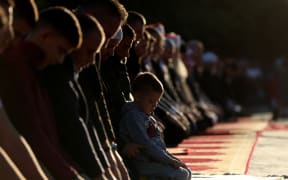 Albanian muslims devotees offer morning prayers to start the Eid al-Fitr festival, which marks the end of the holy fasting month of Ramadan, at the Skenderbej square in Tirana on April 10, 2024. (Photo by Adnan Beci / AFP)
