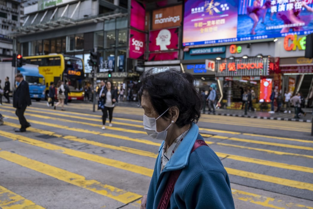 A Women wears a mask as she crosses a road in Tsim Sha Tusi District on January 22, 2019 in Hong Kong, China.