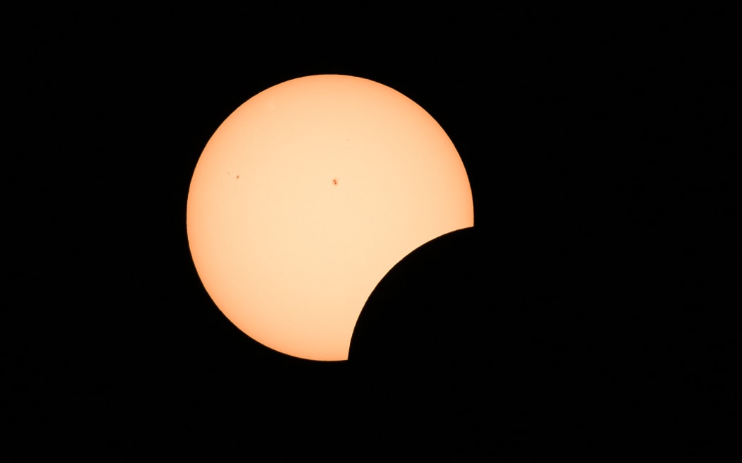 Early stages of a total solar eclipse shows the moon crossing in front of the sun in Bloomington, Indiana, on April 8, 2024.