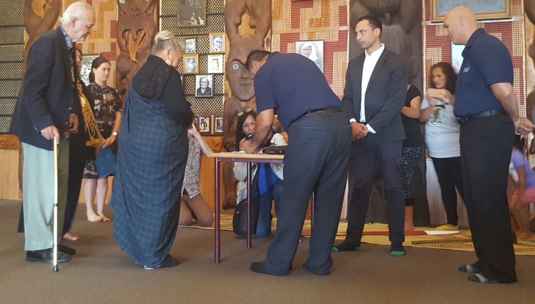 Joe Hawke, left, signs for Ngāti Whātua while Ngati Paoa lead negotiator, Hauauru Rawiri signs for Ngāti Paoa followed by other kaumatua and kuia.
