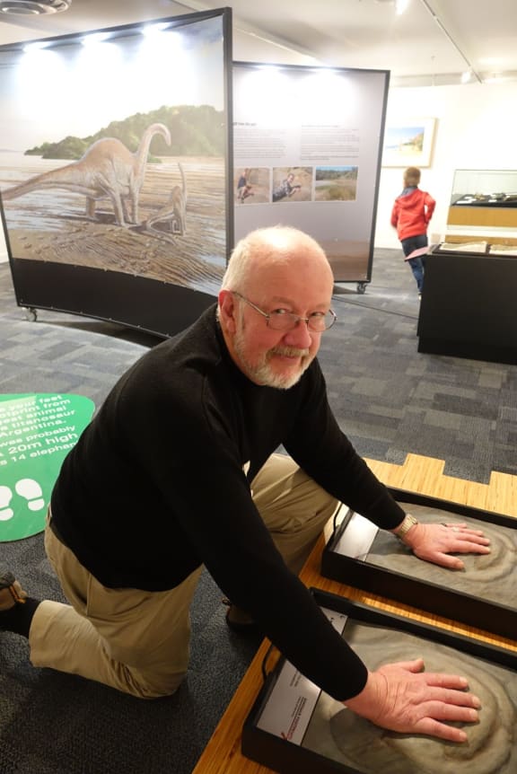 Nelson Provincial Museum chief executive Peter Millward checks out imprints of dinosaur footprints.