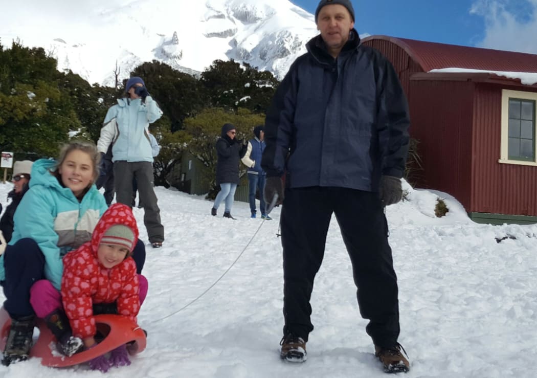 Azharia Martin (red jacket) Samantha Skurr (blue jacket) and David Skurr enjoy the snow at Egmont National Park.