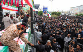 In this picture obtained from Iran's ISNA news agency, mourners attend the funeral of children killed in a reported strike on a primary school in Iran’s Hormozgan province, in Minab on March 3, 2026. Iranian media have reported hundreds of Iranian casualties, including at a girl's school, although AFP reporters have not been able to verify tolls independently. The war launched by the United States and Israel against Iran spread across the Middle East, threatening to plunge the global economy into chaos, with Lebanon and Gulf energy exporters dragged into the conflict. (Photo by AMIRHOSSEIN KHORGOOEI / ISNA / AFP)
