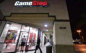 People enter a GameStop store in Alhambra, California on January 27, 2021. - An epic battle is unfolding on Wall Street, with a cast of characters clashing over the fate of GameStop, a struggling chain of video game retail stores.