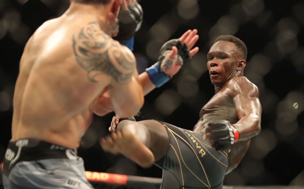 Israel Adesanya exchanges with Robert Whittaker UFC 271 in Houston, 2022.