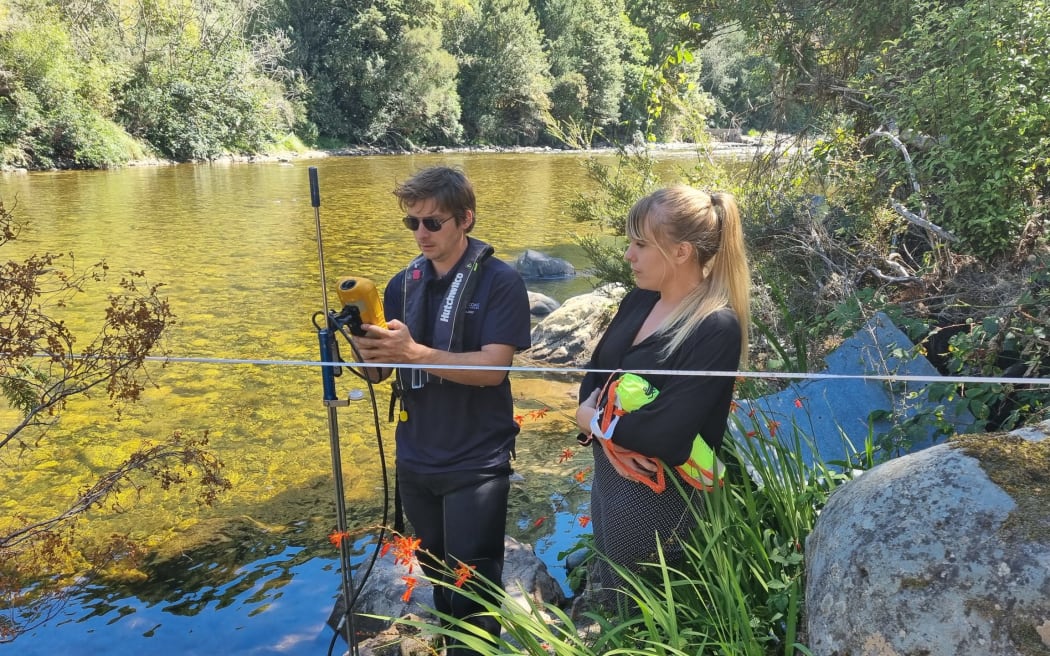 Hydrology manager Samwell Warren and WCRC Environmental Science manager Shanti Morgan setting up cable to record baseline flows in river.