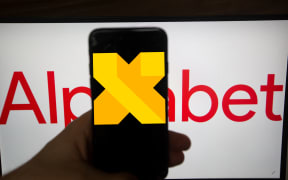 The logo of Google X is seen on a screen. In the background there is the logo of Alphabet. Alphabet is the mother company of Google. It has a revenue of 117 billion dollars. (Photo by Alexander Pohl/NurPhoto) (Photo by Alexander Pohl / NurPhoto / NurPhoto via AFP)