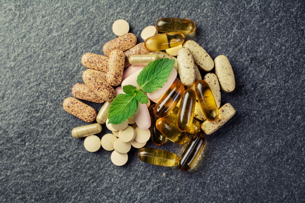 pills and multivitamins  on a black background