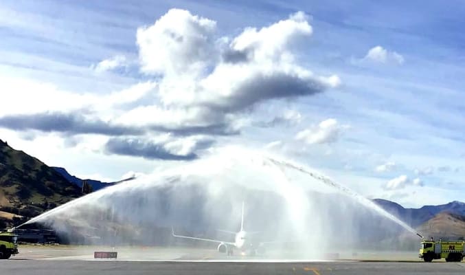 The first quarantine-free flight into Queenstown goes through the water arch - a salute to welcome the special visitors