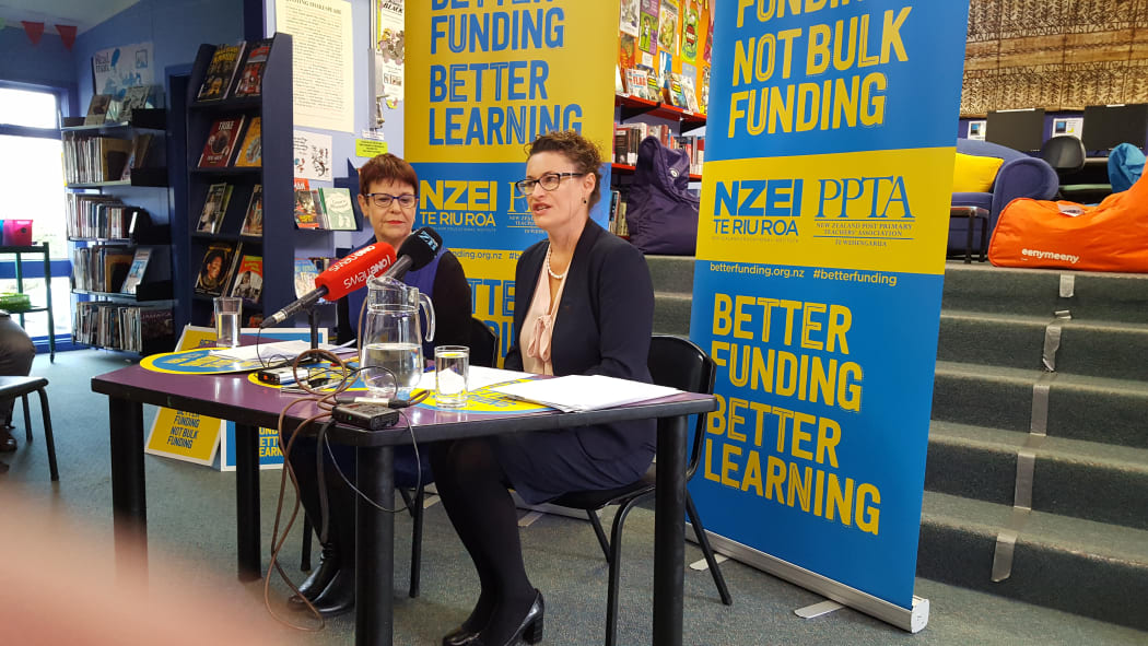 NZEI president Louise Green and PPTA president Angela Roberts announce the results of a vote in which teachers overwhelmingly opposed a proposed change to school funding.