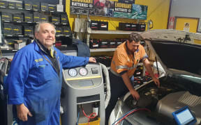Roger Devlin, left, Aaron Williams and Hayden Foote working on the air conditioning on a Lexus Hybrid.
