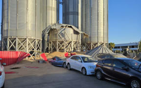 A dozen vehicles at a car dealership in Christchurch have been damaged by a wave of grain when a silo collapsed at a neighbouring flour mill.