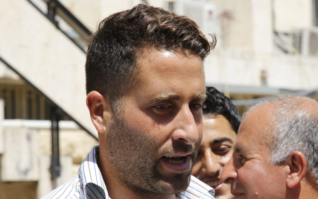 Lebanese father Ali al-Amin, whose ex-wife tried to abduct their children from him, talks to the press as he leaves the court in Baabda northeast of Beirut on 20 April 20.