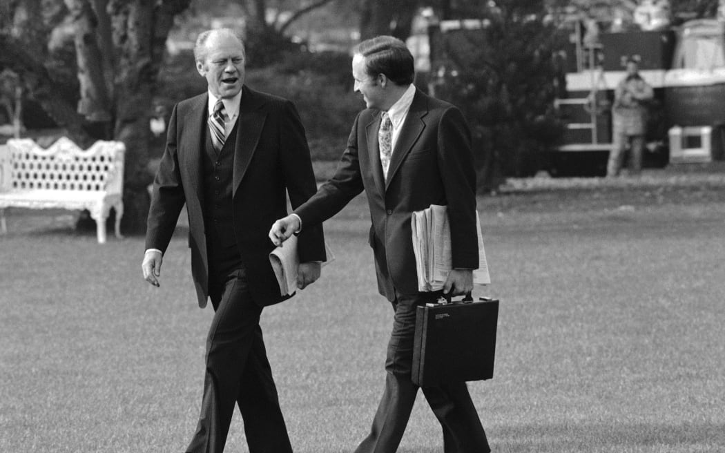 White House Chief of Staff Cheney chats with President Gerald Ford outside the White House as they walk to a helicopter in Washington, DC, in November 1975.
