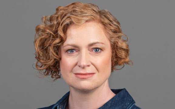 Susie smiling with grey background