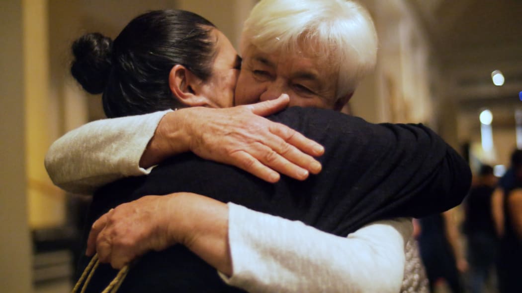 Maureen Lander and Chanel Clarke embrace during the powhiri (welcome) to formally commence the project.