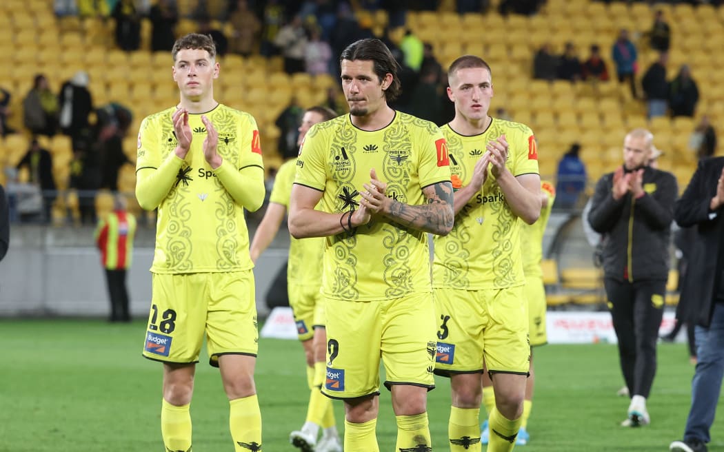 Phoenix Oskar Zawada with team mates  Finn Surman and Lukas Kelly-Heald walk from the field after their loss during the A-League Men’s Semi Final against Melbourne Victory, 2024