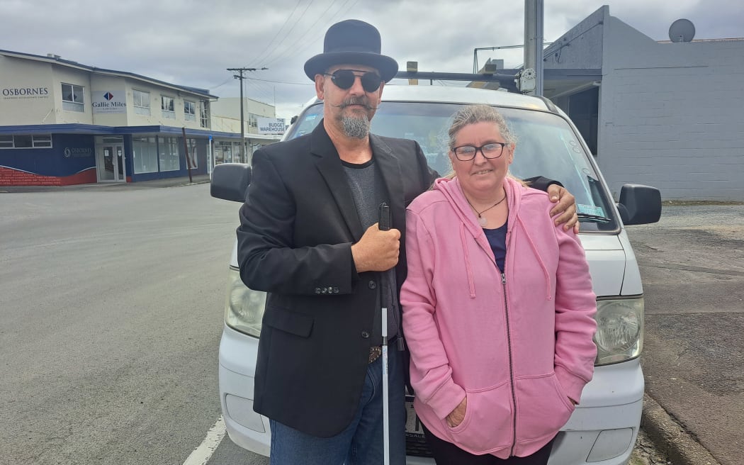Jono and Kathy Davis standing in front of their van.