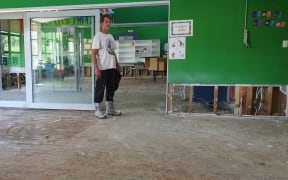 School principal Simon Couling, in a classroom after they were hosed out by firefighters following flooding in Tīnui, near the Wairarapa coast, during Cyclone Gabrielle.