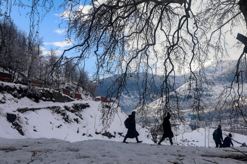 Students on the way to internet during a Kashmir winter.