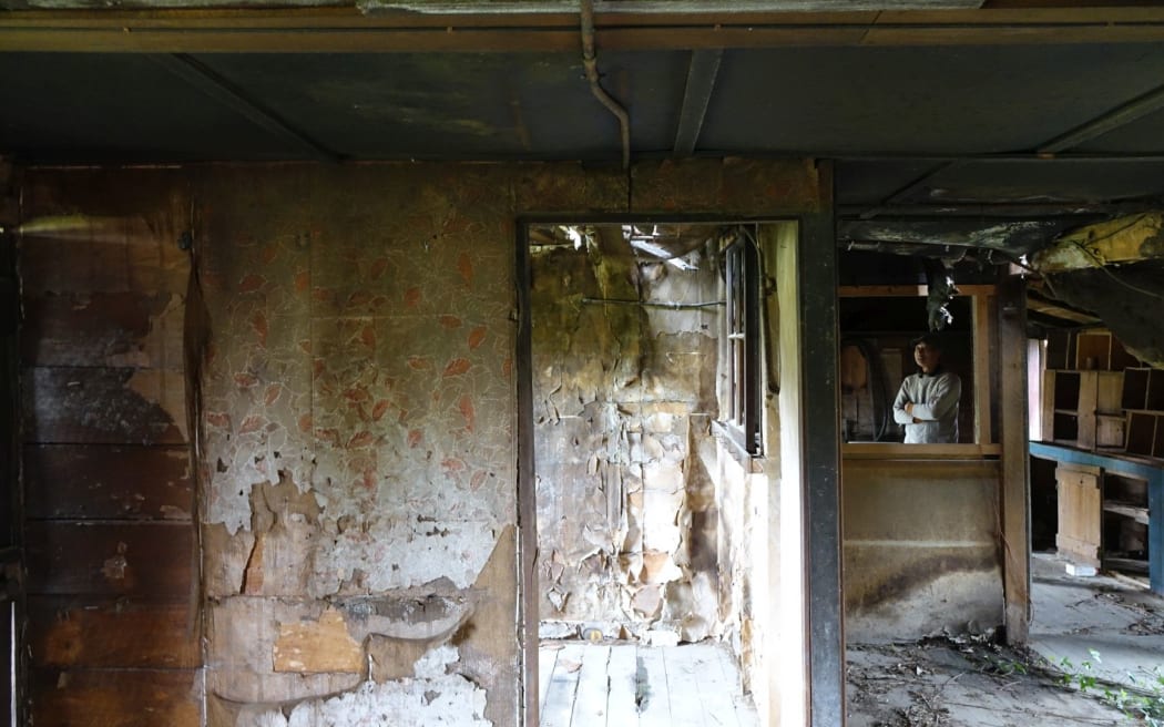 Yep Ng inside the building which housed a communal kitchen and office area at the old Chinese settlement.