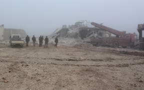 People inspect an area in Etarib district of Aleppo, Syria, after Assad Regime forces used vacuum bombs in what rebel groups say was a violation of ceasefire agreements.