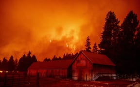 Flames consume multiple homes as the Caldor fire pushes into the Echo Summit area, California on August 30, 2021.