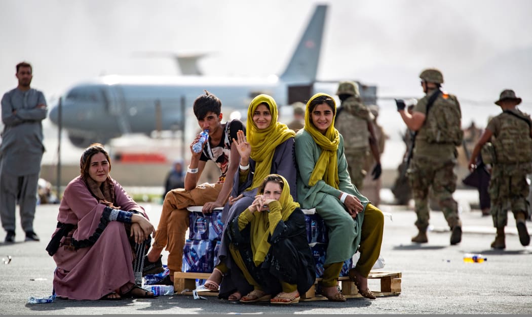 Evacuee children wait for the next flight after being manifested at Hamid Karzai International Airport, Aug. 19. U.S. service members