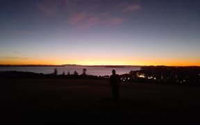 Steam from the umu at Takaparawhau have risen upward towards the stars, as Kai is lifted from the ground.