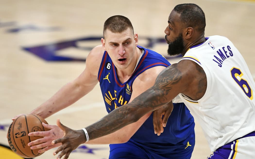 Nikola Jokic (L) of the Denver Nuggets handles the ball against LeBron James of the Los Angeles Lakers during game three of the Western Conference Finals in California.