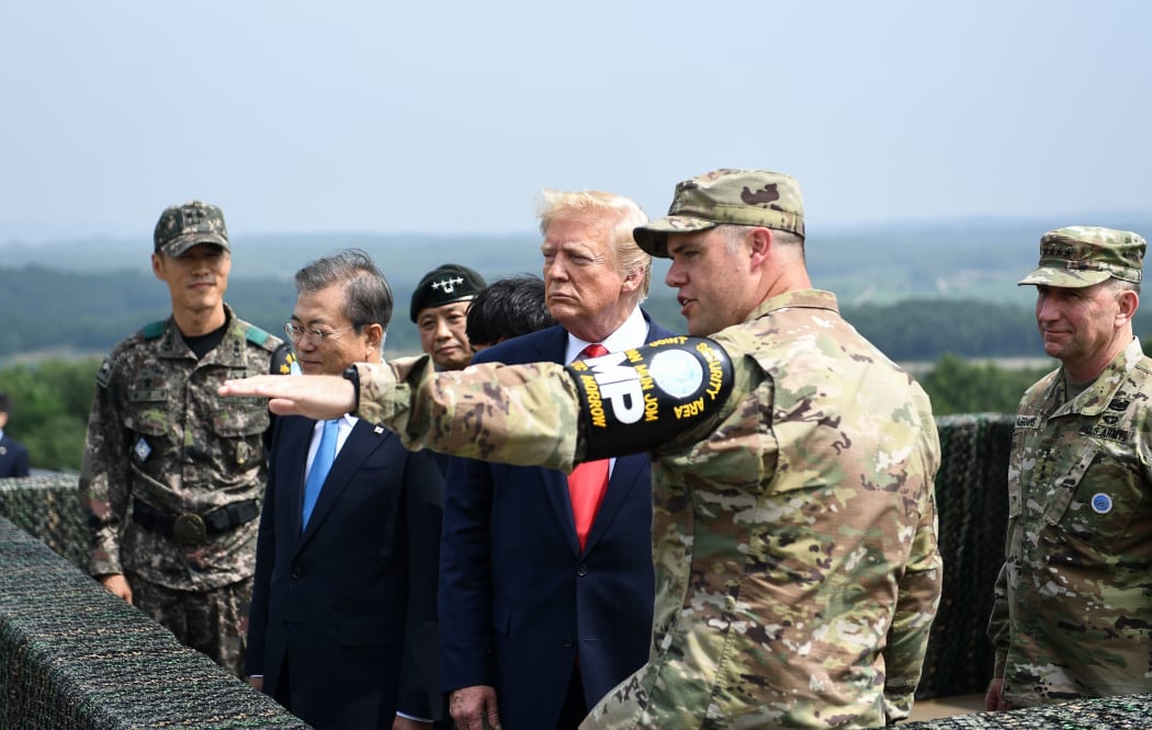 US President Donald Trump (3rd R) and South Korean President Moon Jae-in (2nd L) visit an observation post in the Joint Security Area (JSA) at Panmunjom in the Demilitarized Zone (DMZ) separating North and South Korea on June 30, 2019.
