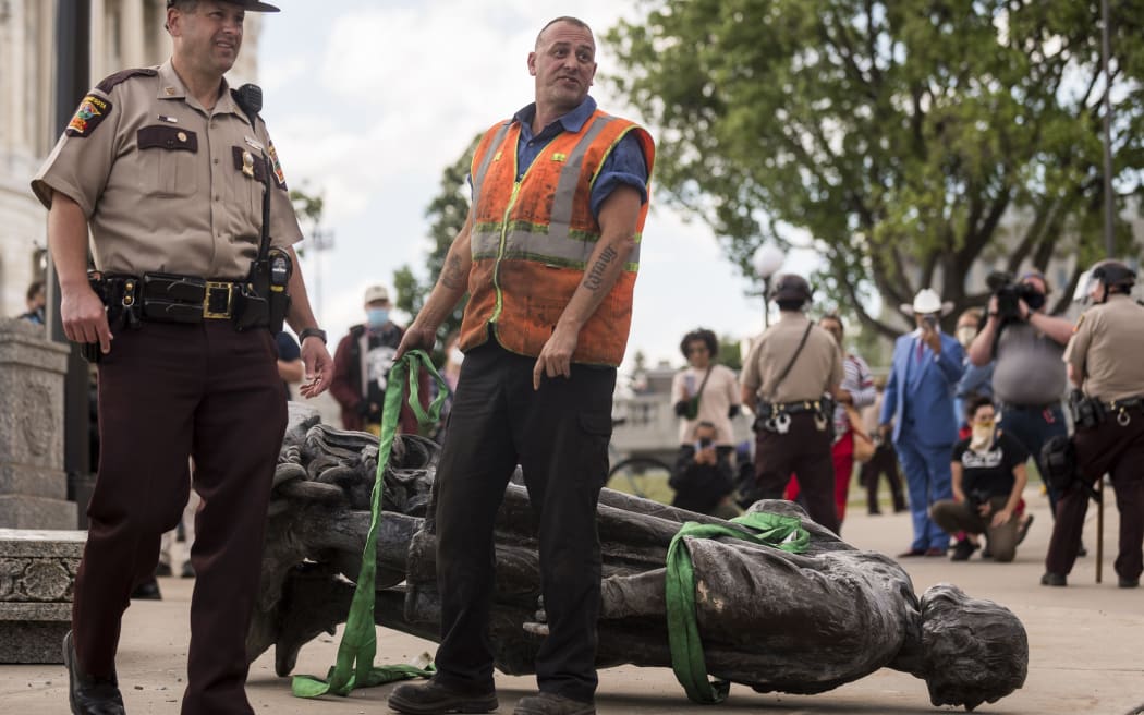 A statue of Christopher Columbus, which was toppled to the ground by protesters, is loaded onto a truck on the grounds of the State Capitol on June 10, 2020 in St Paul, Minnesota.