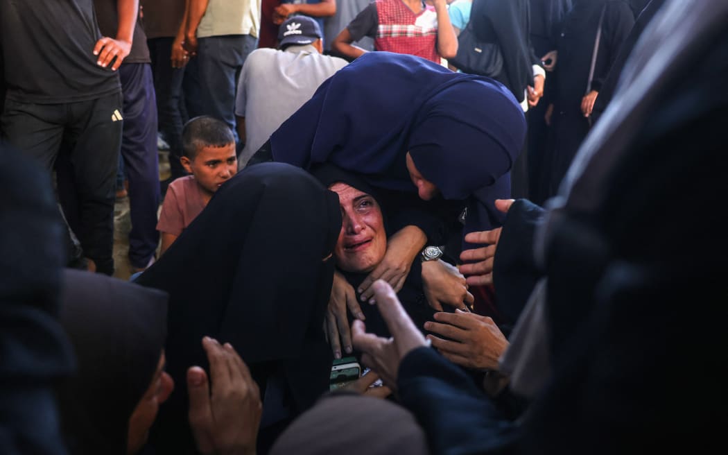 Palestinians mourn relatives killed in Israeli strikes on Gaza City the previous night, at Al-Shifa hospital.