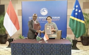 The foreign ministers of Solomon Islands and Indonesia, Jeremiah Manele (Left) and Retno Marsudi, pose for a photo after signing a bilateral development cooperation framework agreement. Bali, 5 December 2019