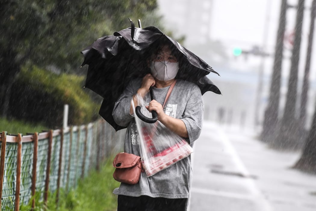 A woman walks in heavy rain as Typhoon Haishen approaches in Kagoshima, Kagoshima prefecture on September 6, 2020.