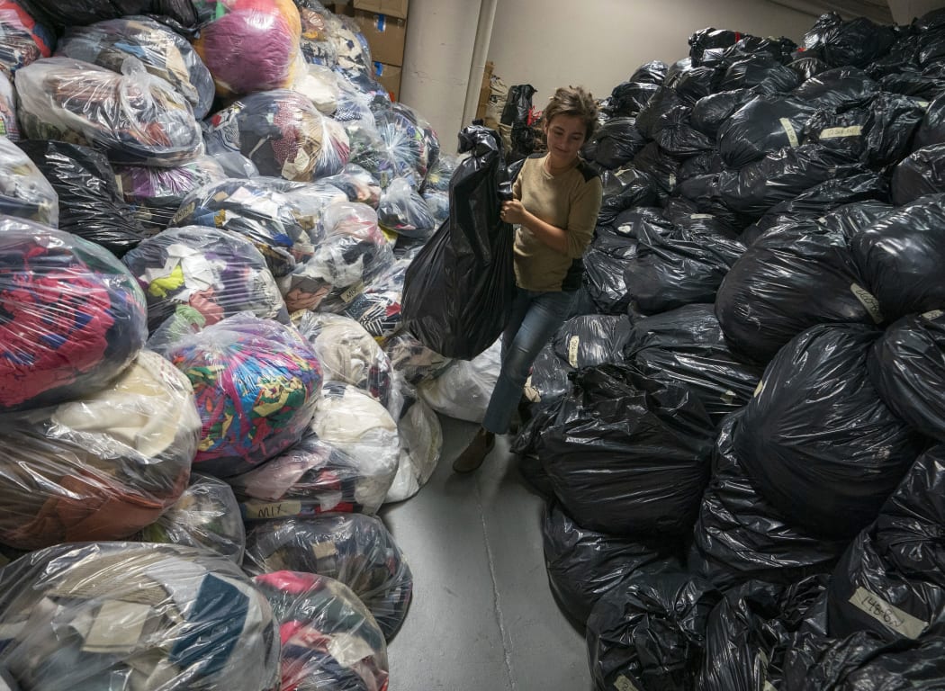 A Fabscrap employee sorts  bags of fabric on February 1, 2019 at the company's warehouse in New York. - The fashion industry generates tons of textile waste, especially in New York, a shopping temple where a "Fashion Week" is held twice a year, which alone generates impressive amounts of waste. So for two years, an association, Fabscrap, offers an alternative to fight against this huge textile mess. Fabscrap provides pickup of fabric scraps from commercial businesses in New York, including fashion brands, interior designers, cutting rooms, tailors, costume and set designers, and schools. (Photo by Don Emmert / AFP)