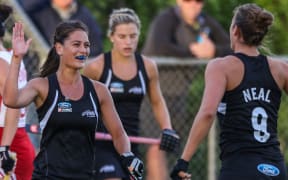 The Black Sticks women celebrate a goal.