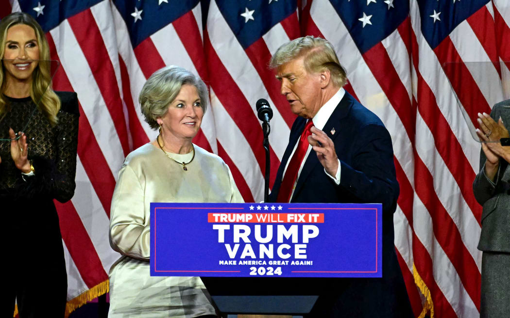 Former US President and Republican presidential candidate Donald Trump greets his campaign manager Susie Wiles (L) during an election night event at the West Palm Beach Convention Center in West Palm Beach, Florida, on November 6, 2024. - Republican former president Donald Trump closed in on a new term in the White House early November 6, 2024, just needing a handful of electoral votes to defeat Democratic Vice President Kamala Harris. (Photo by Jim WATSON / AFP)