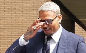 US rapper Chris Brown reacts as he leaves Southwark Crown Court in London, June 20, 2025, after pleading not guilty to attempting to cause grievous bodily harm with intent during an alleged London nightclub brawl in 2023. (Photo by CARLOS JASSO / AFP)