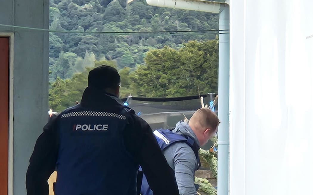 Police can be seen executing a search warrant at a Taraire Street property in Kaikohe following the death of Linda Woods on 1 June.