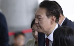 Former President Yoon Suk-yeol arrives at the special counsel's office at the Seoul High Prosecutors' Office in Seocho District, Seoul, South Korea, on June 28, 2025, for a face-to-face interrogation. Yoon, who is under investigation by the special counsel for alleged illegal imposition of martial law and insurrection, once again refuses to answer reporters' questions before entering the office. (Photo by Chris Jung/NurPhoto) (Photo by Chris Jung / NurPhoto via AFP)