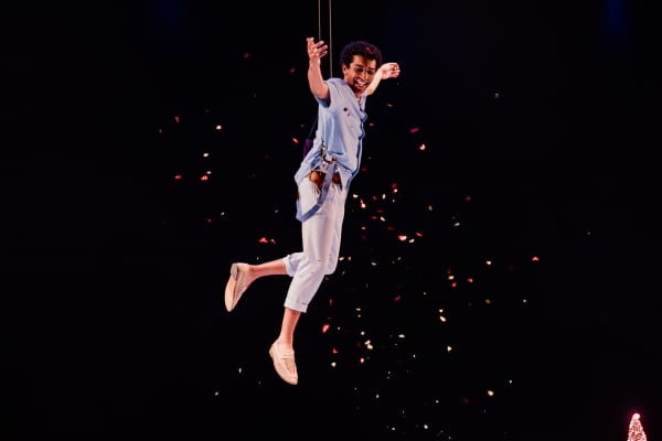 Peter Pan (Theo Shakes) is suspended above the stage in an impressive show of technical theatrics.