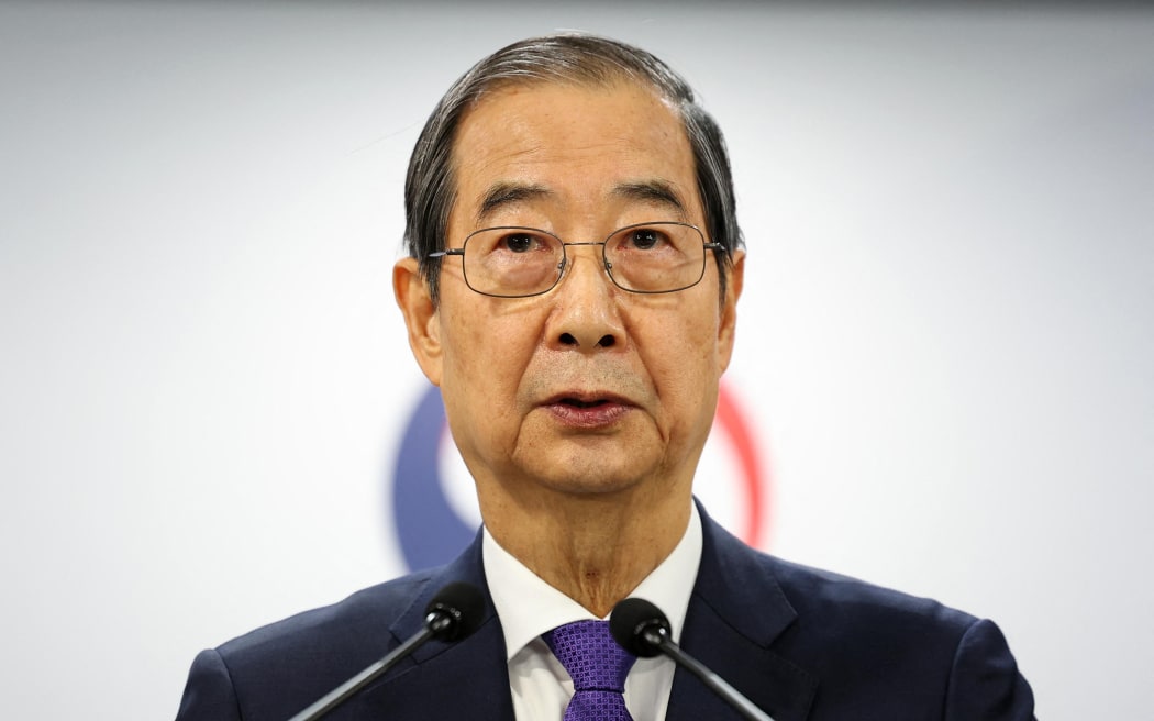 South Korea Prime Minister and acting President Han Duck-soo speaks in his address to the nation at the Government Complex in Seoul on December 26, 2024. - South Korea's opposition said on December 26 it had filed an impeachment motion against acting president Han Duck-soo, after he refused to appoint Constitutional Court judges to complete the process of removing his predecessor from office. (Photo by YONHAP / AFP) / - South Korea OUT / NO USE AFTER JANUARY 25, 2025 05:35:52 GMT -  - SOUTH KOREA OUT / NO ARCHIVES -  RESTRICTED TO SUBSCRIPTION USE